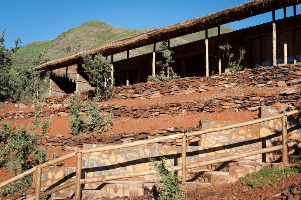 The stone and timber Mountainside Retreat building at Maliba on a mountain slope